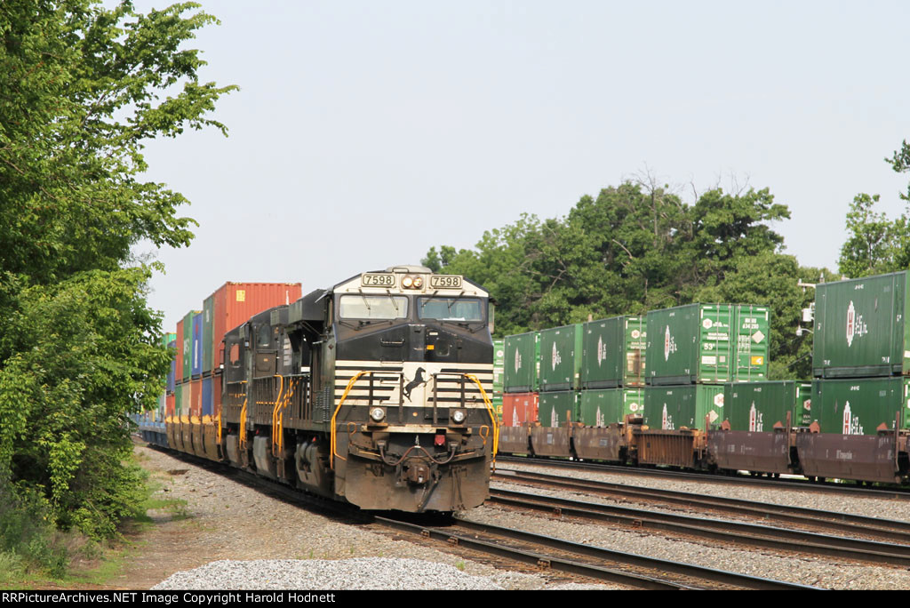 NS 7598 brings a cut of cars out of the old yard for its train (# 214)